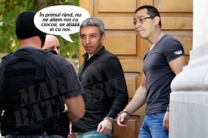 File photo of Darie and Dogaru, suspects charged in the theft of seven paintings from a Dutch museum, leaving a court building handcuffed and escorted by police in Bucharest